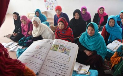 A group of students taking notes in USAID’s Bass